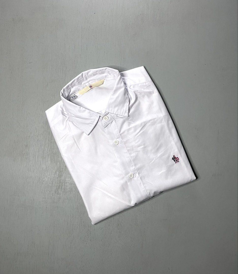 Moncler White Long Sleeve Button Down Shirt Size 3 (Category: Longsleeves) located in Catbalogan. Submitted by yellfindss (Listing ID 1466744323, Image 1). Description: Moncler long sleeve button down shirt in white. Classic collar, front button closure with red, white, and blue placket trim. Small Moncler logo embroidered on the left chest. Tag size 3 indicated on the collar label. Clean cotton fabric, nice tailoring throughout. -22.5/29.