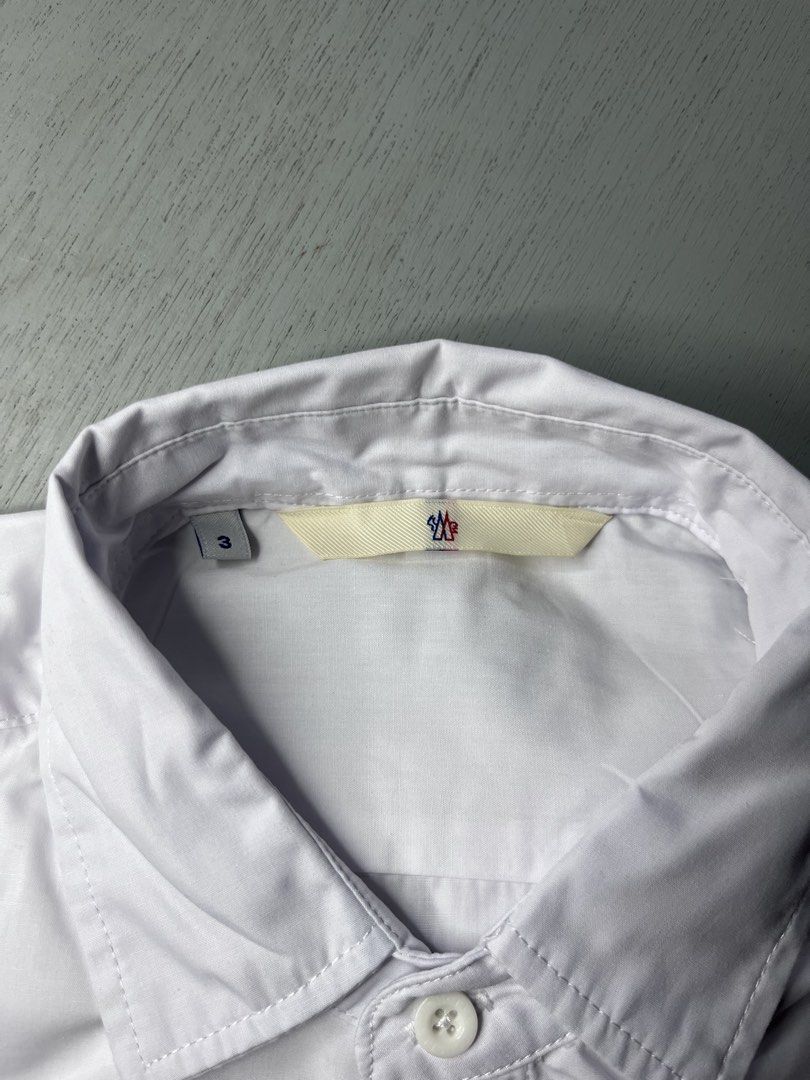 Moncler White Long Sleeve Button Down Shirt Size 3 (Category: Longsleeves) located in Catbalogan. Submitted by yellfindss (Listing ID 1466744323, Image 2). Description: Moncler long sleeve button down shirt in white. Classic collar, front button closure with red, white, and blue placket trim. Small Moncler logo embroidered on the left chest. Tag size 3 indicated on the collar label. Clean cotton fabric, nice tailoring throughout. -22.5/29.