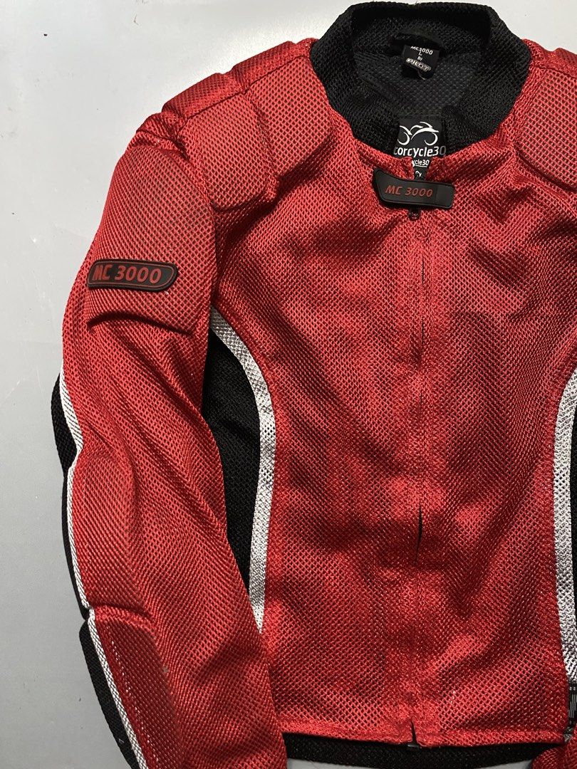 Motorcycle3000 By Pilot Red Mesh Riding Jacket Size L (Category: Coats, Jackets and Outerwear) located in Manila. Submitted by delunakenn94368 (Listing ID 1466695695, Image 3). Description: - Brand: Pilot - Size: L - Color: Bright red mesh with black side panels and reflective silver piping - Protection: Built-in shoulder padding and back protection panels - Features: Heavy-duty zipper closure, neck tab, and great airflow for hot weather riding -