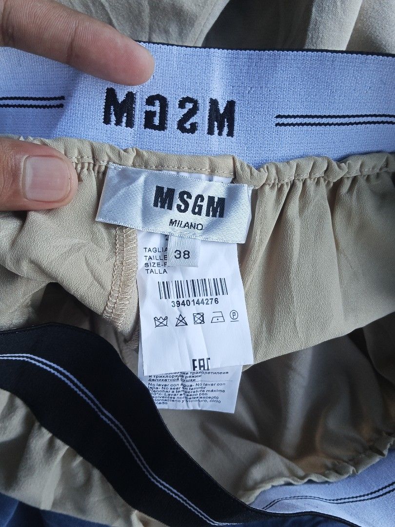 MSGM Beige Shorts with Branded Elastic Waistband (Category: Shorts) located in Lingayen. Submitted by rahzzelula73279 (Listing ID 1466713439, Image 3). Description: - Brand: MSGM - Color: Beige - Waistband: Elastic with iconic white and blue striped brand lettering - Pockets: Two back welt pockets - Style: Clean finish, ideal for casual wear - Condition: Great piece, highly versatile.