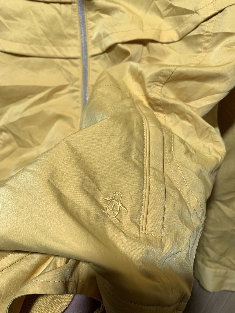 Munsingwear Yellow Windbreaker Jacket (Category: Coats, Jackets and Outerwear) located in Kidapawan. Submitted by nicnic1_gem (Listing ID 1466713824, Image 3). Description: - Brand: Munsingwear - Color: Bright yellow - Features: Stand collar, full zip front with custom ring pull - Pockets: Dual zippered front pockets with signature penguin logo pull tabs - Details: Embroidered penguin logo on the chest and adjustable snap button cuffs - Condition