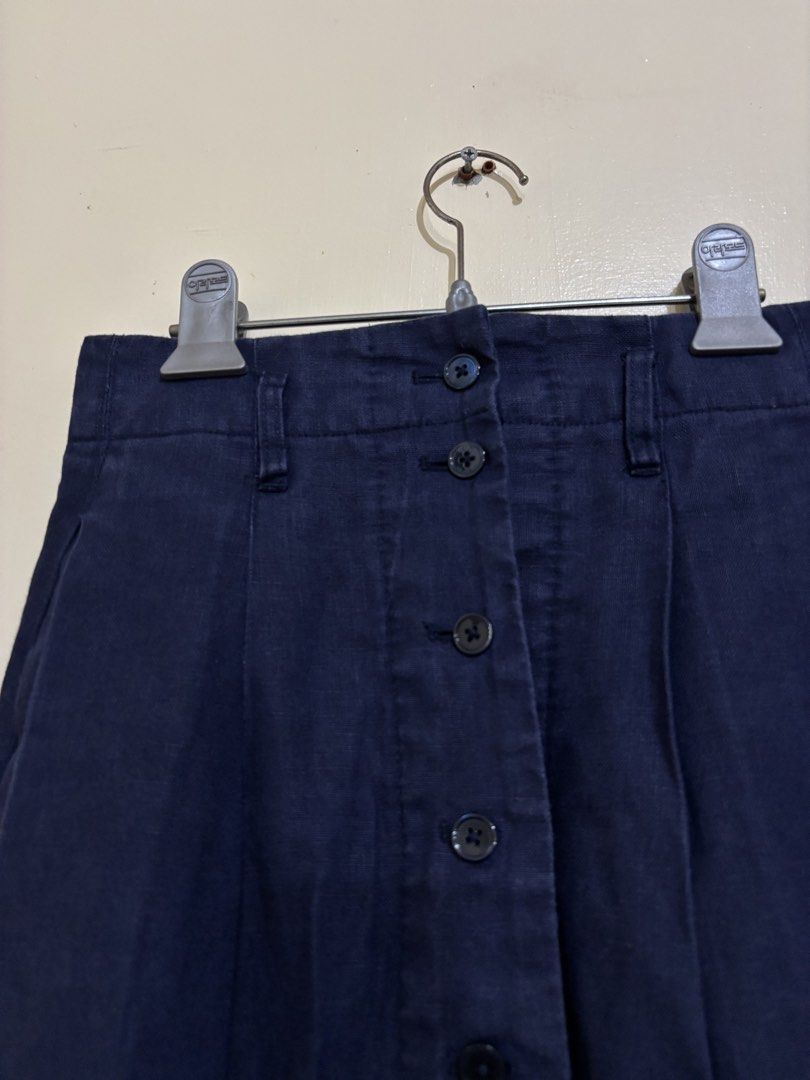 Navy Blue Linen Button-Front Midi Skirt Size XS (Category: Skirts) located in Balayan. Submitted by authenticfindsbymrb (Listing ID 1466705565, Image 2). Description: - Color: Dark blue - Material: Branded 100% breathable linen, machine washable - Size: FR 34, US XXS, EU XS, JP 5 (Waist measures roughly 13" flat) - Fit: High-waisted midi length with built-in belt loops - Details: Full button-down front with matching dark buttons, front pleats, an