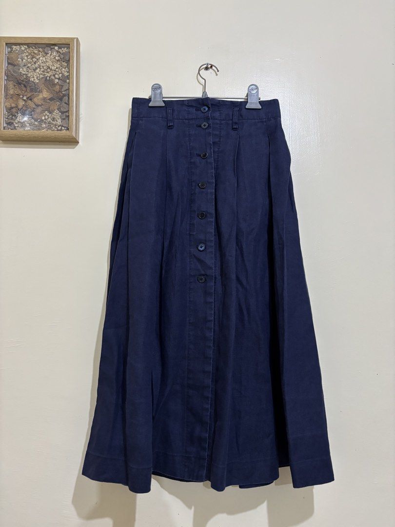 Navy Blue Linen Button-Front Midi Skirt Size XS (Category: Skirts) located in Balayan. Submitted by authenticfindsbymrb (Listing ID 1466705565, Image 1). Description: - Color: Dark blue - Material: Branded 100% breathable linen, machine washable - Size: FR 34, US XXS, EU XS, JP 5 (Waist measures roughly 13" flat) - Fit: High-waisted midi length with built-in belt loops - Details: Full button-down front with matching dark buttons, front pleats, an