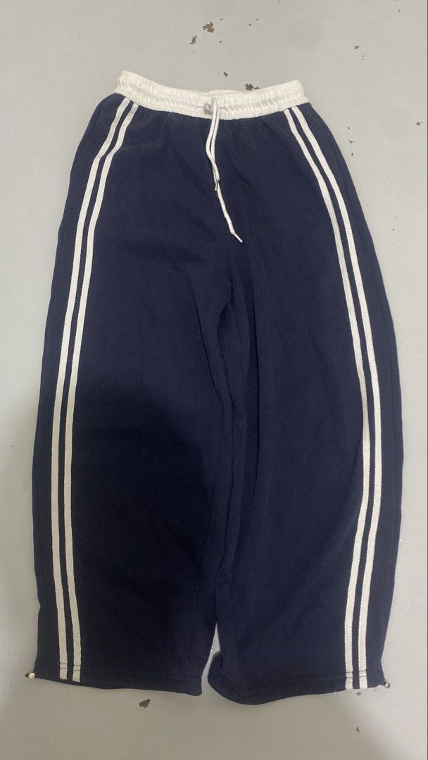 Navy Blue Sweatpants with White Side Stripes (Category: Joggers) located in Manila. Submitted by isthissnoopy (Listing ID 1466739503, Image 1). Description: - Color: Navy blue - Design: Dual white stripes on both sides - Waistband: White elastic with matching adjustable drawstring - Fit: Relaxed fit for all-day comfort - Hem: Adjustable toggles to customize the look - Style: Essential streetwear staple, great for lounging or casual outings.