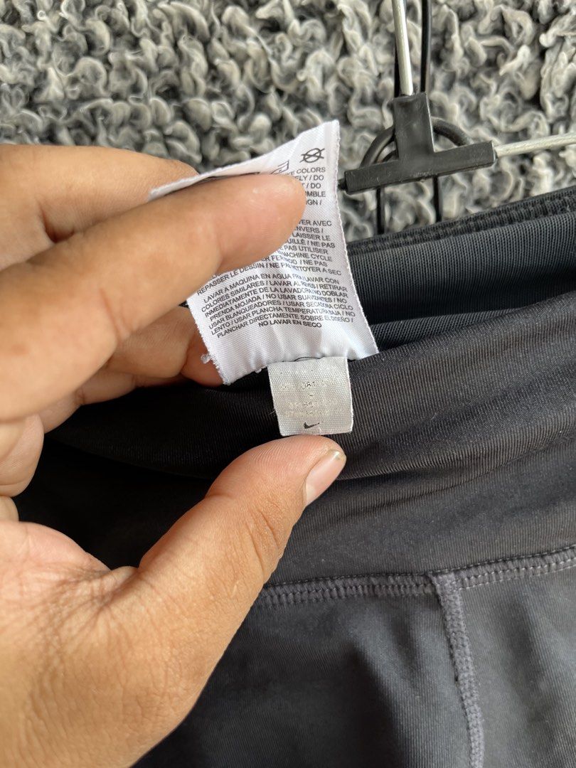 Nike 3/4 cropped athletic tights | Size S (Category: Activewear) located in General Trias. Submitted by zrchustle.604 (Listing ID 1466595210, Image 3). Description: Nike 3/4 cropped athletic tights, highlighted by a large textured Swoosh logo on the left leg..