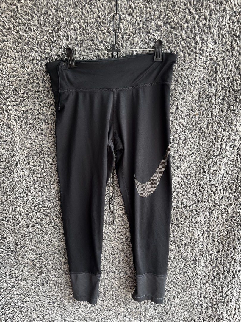 Nike 3/4 cropped athletic tights | Size S (Category: Activewear) located in General Trias. Submitted by zrchustle.604 (Listing ID 1466595210, Image 1). Description: Nike 3/4 cropped athletic tights, highlighted by a large textured Swoosh logo on the left leg..