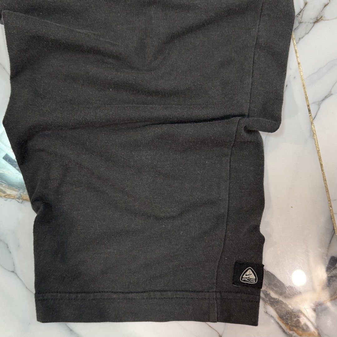 Nike ACG Black Sweatpants Size L (Category: Joggers) located in Manila. Submitted by fastflip.ph (Listing ID 1466727465, Image 2). Description: - Brand: Nike ACG - Color: Black - Size: Large (L) - Made in Taiwan - Material: Poly-cotton-spandex blend - Fit: Relaxed fit - Waistband: Elastic with adjustable drawstring - Pockets: Includes a secure zippered back pocket - Details: Subtle ACG branding on the lower leg hem - Condition: Excellent / Ready 