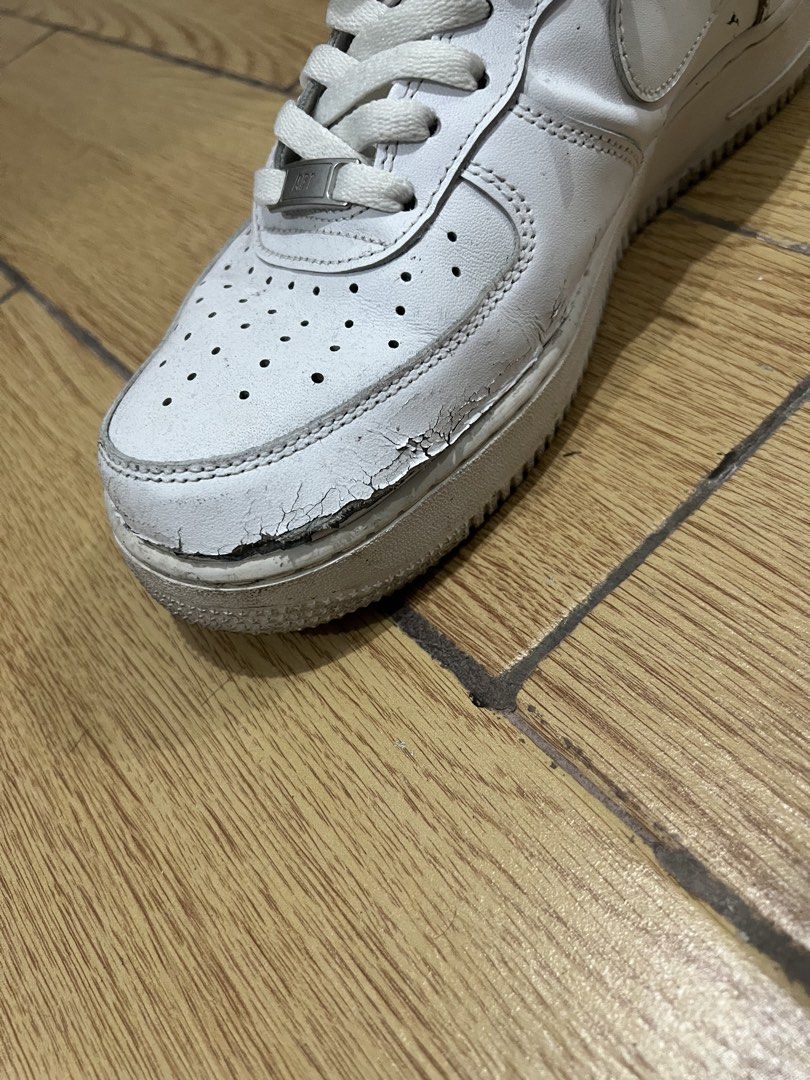 Nike Air Force 1 Triple White (Category: Sneakers) located in Manila. Submitted by tankalvin479038 (Listing ID 1466730254, Image 2). Description: - Brand: Nike Air Force 1 - Color: Triple White - Condition: Damaged, noticeable creasing and cracking on the toe box, regular wear and dirt marks present.