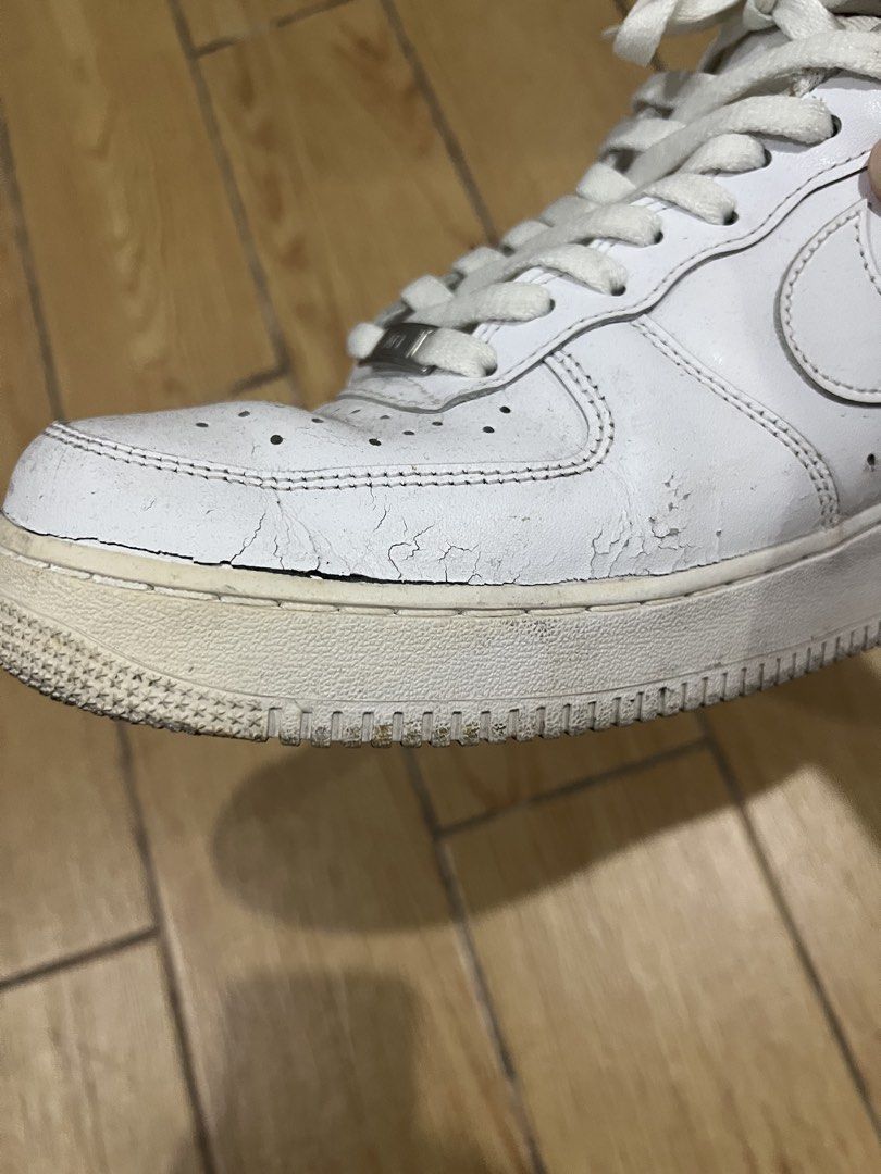 Nike Air Force 1 Triple White (Category: Sneakers) located in Manila. Submitted by tankalvin479038 (Listing ID 1466730254, Image 3). Description: - Brand: Nike Air Force 1 - Color: Triple White - Condition: Damaged, noticeable creasing and cracking on the toe box, regular wear and dirt marks present.