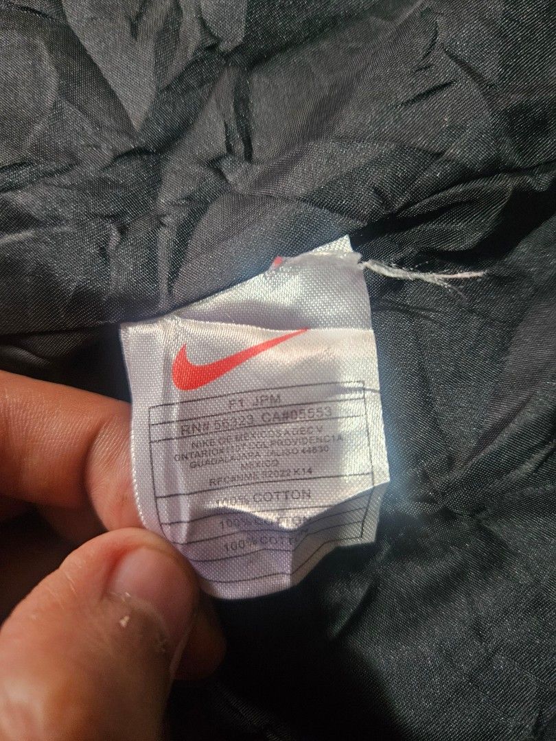 Nike Black Hooded Jacket with Red Lining Size M (Category: Coats, Jackets and Outerwear) located in Manila. Submitted by shanshan.river (Listing ID 1466685297, Image 3). Description: - Brand: Nike - Style: Hooded jacket with full front closure and button flap - Color: Black with red inner lining and drawstrings - Branding: White Nike swoosh on the chest and large Nike logo on the back - Size: Medium - Material: 100% cotton, made in China - Featur