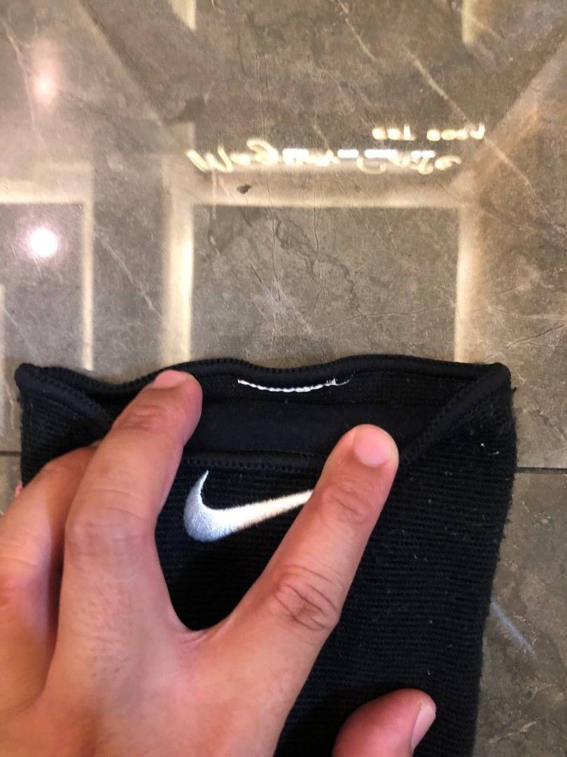 Nike Black Knee Pad with White Logo (Category: Shorts) located in Santa Cruz. Submitted by remsonnnc (Listing ID 1466625163, Image 2). Description: - Authentic Black Nike knee pad - Classic white embroidered swoosh logo on the front - Stretchy fabric sleeve style for a snug fit - Strong elastic stretch on the top opening to prevent slipping - Ideal for basketball, volleyball, and other contact sports - Condition: Normal wear from previous use, bu
