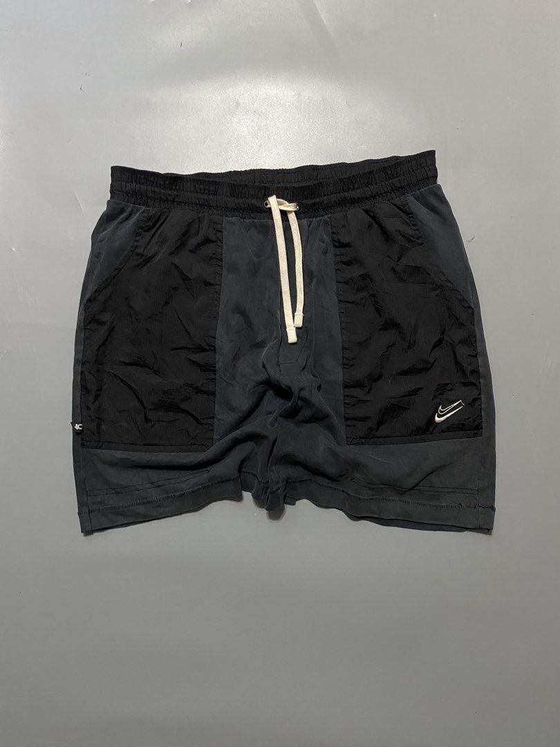 Nike Black Nylon Cargo Shorts Size L (Category: Shorts) located in Manila. Submitted by delunakenn94368 (Listing ID 1466696005, Image 1). Description: - Brand: Nike - Color: Black - Size: Large (L) - Material: 100% cotton main fabric with nylon pocket details - Waistband: Elastic with thick cream drawstring - Design: Two front cargo-style contrast panels with white embroidered swoosh on lower left leg - Storage: Single zip pocket on back right - 