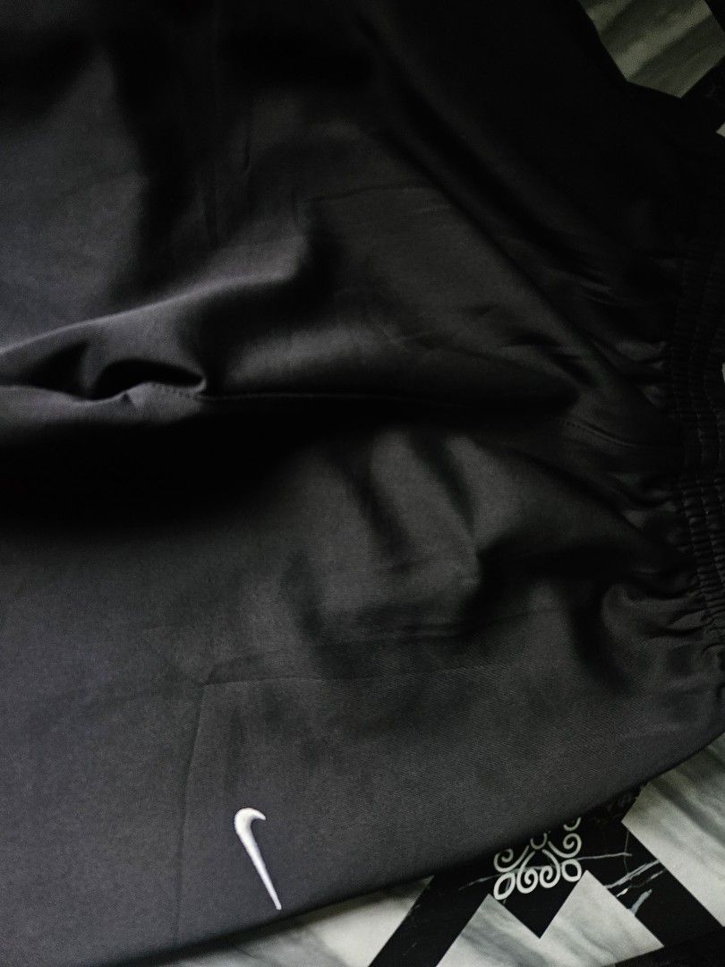 Nike Black Track Pants Size L (Category: Joggers) located in Manila. Submitted by shanshan.river (Listing ID 1466685326, Image 3). Description: - Brand/Model: Nike black track pants - Size: L - Fit: Straight-leg style with an easy elastic waistband - Details: Small white Nike swoosh logo near the hip - Origin: Made in Indonesia - Condition: Clean fabric, ready to wear.