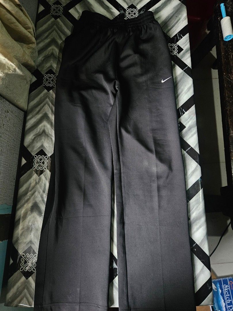Nike Black Track Pants Size L (Category: Joggers) located in Manila. Submitted by shanshan.river (Listing ID 1466685326, Image 1). Description: - Brand/Model: Nike black track pants - Size: L - Fit: Straight-leg style with an easy elastic waistband - Details: Small white Nike swoosh logo near the hip - Origin: Made in Indonesia - Condition: Clean fabric, ready to wear.