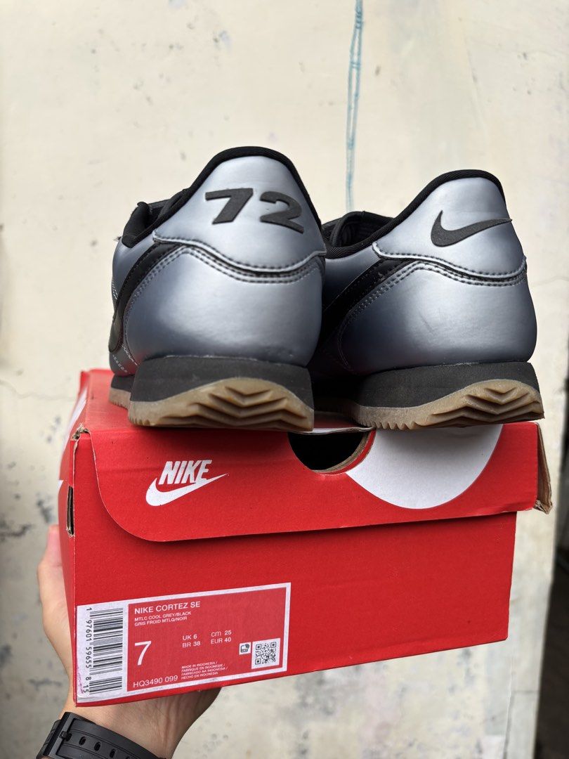 Nike Cortez SE Metallic Cool Grey Black (Category: Sneakers) located in Quezon. Submitted by hiddengem69 (Listing ID 1466772088, Image 3). Description: - Brand: Nike Cortez SE - Colorway: Metallic Cool Grey and Black - Size: US 7 / UK 6 / EUR 40 - Condition: Brand new, unworn, fresh from packaging - Design Details: Unique shroud flap over laces with Swoosh logo and '72' on the heel tab - Packaging: Includes original red Nike box Bought from Nike 