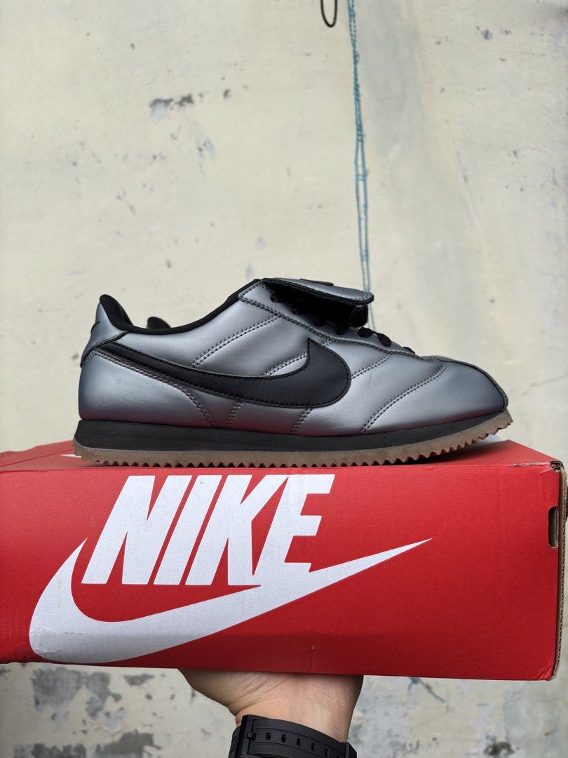 Nike Cortez SE Metallic Cool Grey Black (Category: Sneakers) located in Quezon. Submitted by hiddengem69 (Listing ID 1466772088, Image 2). Description: - Brand: Nike Cortez SE - Colorway: Metallic Cool Grey and Black - Size: US 7 / UK 6 / EUR 40 - Condition: Brand new, unworn, fresh from packaging - Design Details: Unique shroud flap over laces with Swoosh logo and '72' on the heel tab - Packaging: Includes original red Nike box Bought from Nike 