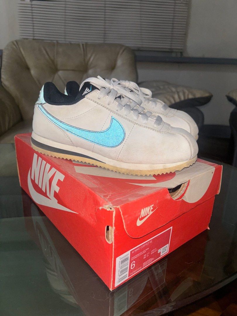 Nike Cortez SE Women's Phantom Black Light Bone (Category: Sneakers) located in Cavite. Submitted by ohitsaj (Listing ID 1466673330, Image 2). Description: Nike Cortez SE women's sneakers in phantom, black, and light bone colorway. Size US 6, UK 3.5, EUR 36.5. Features light blue swoosh detailing and black heel collar. Original Nike shoebox included. Soles show minor dirt from previous wear. Uppers show light creasing and dust..