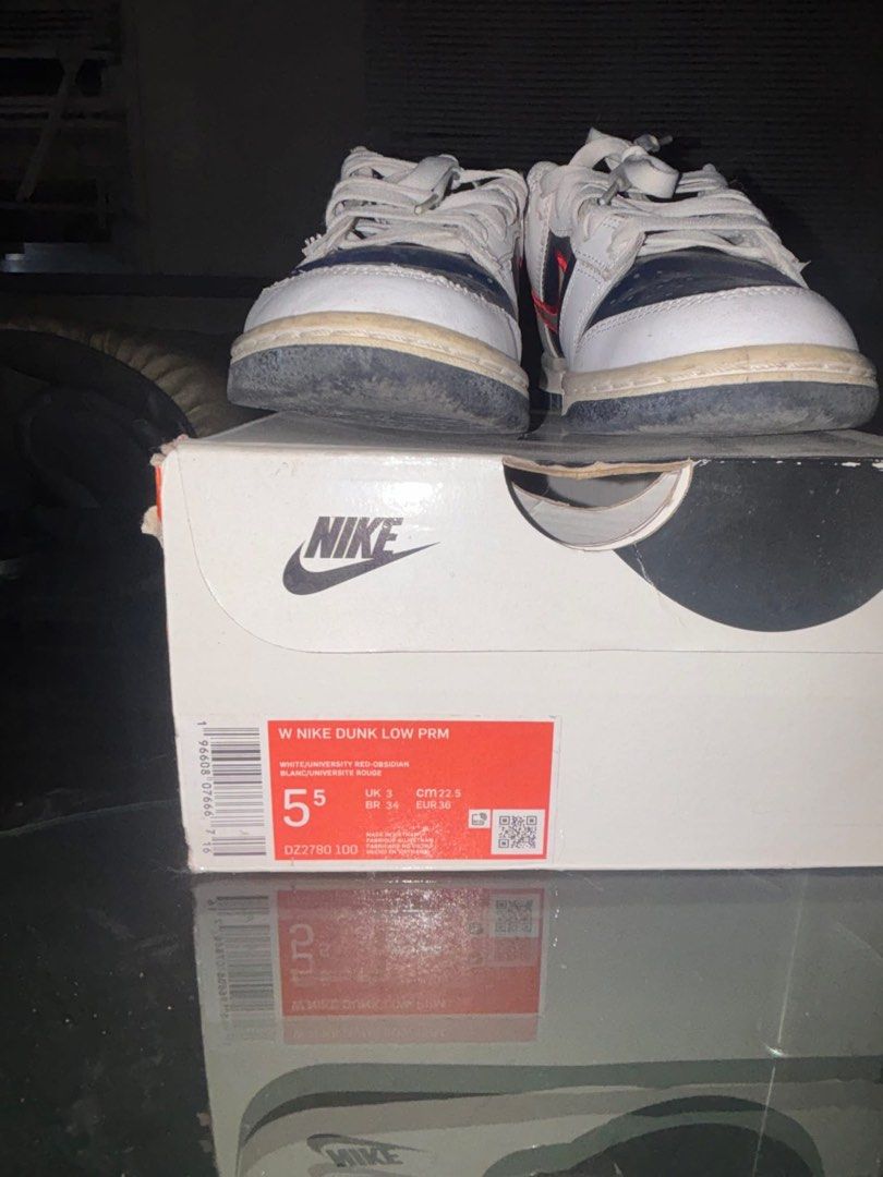 Nike Dunk Low PRM White University Red Obsidian (Category: Sneakers) located in Cavite. Submitted by ohitsaj (Listing ID 1466673022, Image 2). Description: - Model: Nike Dunk Low PRM - Colorway: White / University Red / Obsidian - Size: US 5.5 Women's / UK 3 / EUR 36 - Materials: Suede and leather upper with layered swoosh outline - Inclusions: Original box included - Condition: Soles show minor wear and scuffing from previous use.