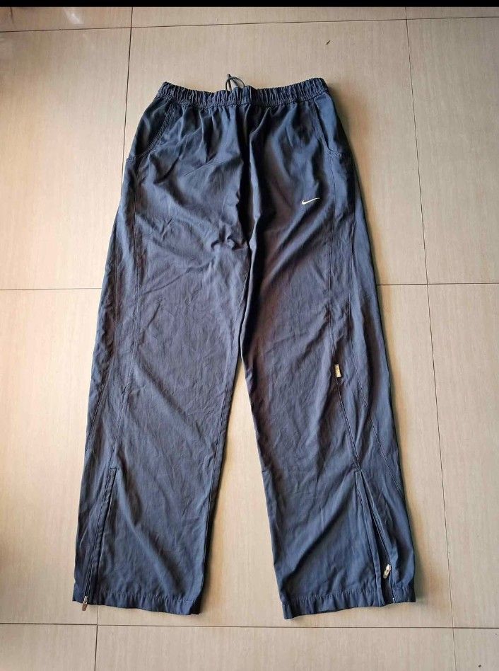 Nike Embroidered Track Pants (Category: Joggers) located in Manila. Submitted by rhoydyyy (Listing ID 1466649537, Image 1). Description: Size on Tag: XL Length: 40 Issue: non working yung zipper sa left leg(fixable), cut yung wash tag pwede meetup, pickup kung malapit jnt kapag malayo.