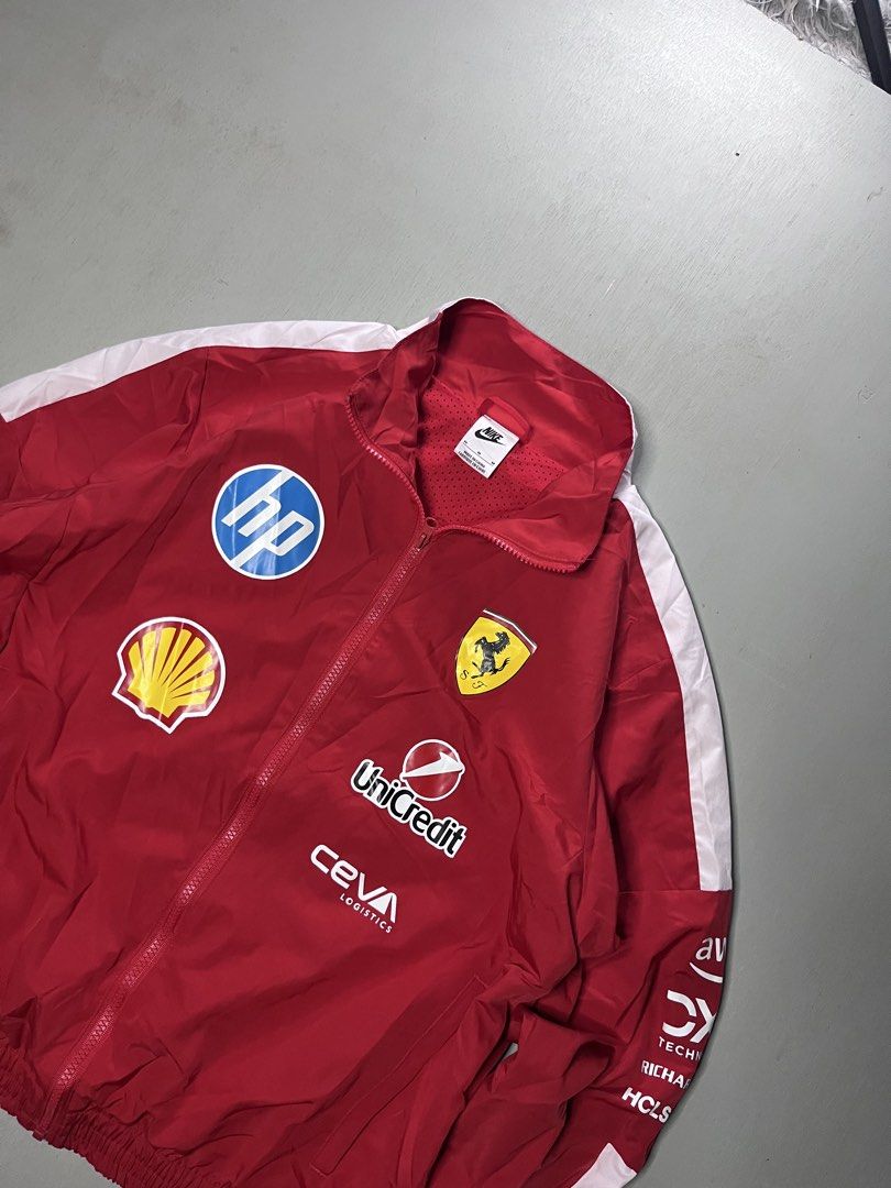 Nike Ferrari F1 Racing Jacket Size M (Category: Coats, Jackets and Outerwear) located in Catbalogan. Submitted by yellfindss (Listing ID 1466744320, Image 2). Description: - Brand: Nike x Scuderia Ferrari Formula 1 -22/25 - Color: Red with white sleeve panel stripes - Size: Medium - Closure: Full zip with stand collar - Lining: Breathable mesh inner lining - Details: Features authentic printed sponsor logos (HP, Shell, UniCredit, Ceva Logistics, 