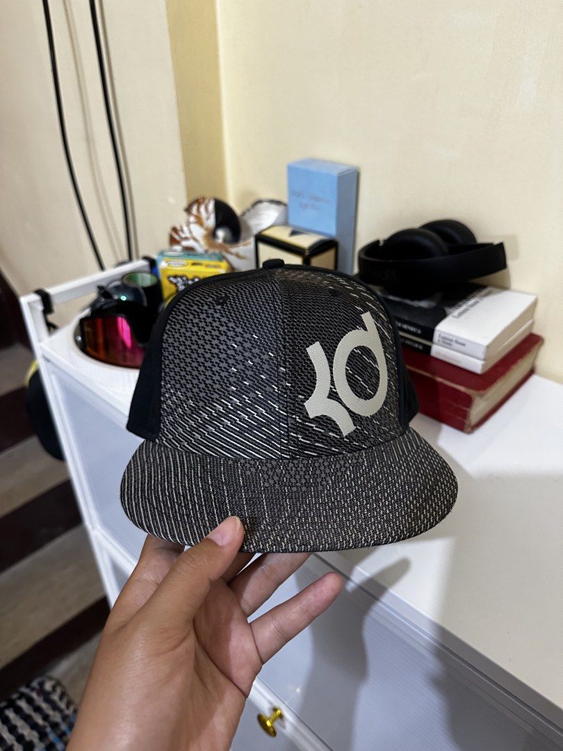 Nike KD True Kevin Durant Snapback Cap (Category: Caps & Hats) located in Baler. Submitted by sidequester (Listing ID 1466569710, Image 1). Description: - Brand: Nike Kevin Durant - Color: Black and grey knit pattern with solid black back - Fit: Adjustable plastic snap closure - Condition: Brand new with original store sticker on the under-brim - MOP: Any online bank or e-wallets - MOD: Can do meet up and ship nationwide - Can offer discount or b