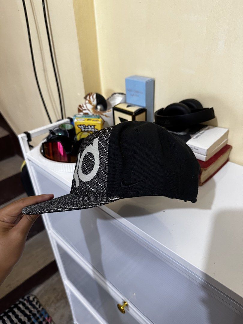 Nike KD True Kevin Durant Snapback Cap (Category: Caps & Hats) located in Baler. Submitted by sidequester (Listing ID 1466569710, Image 2). Description: - Brand: Nike Kevin Durant - Color: Black and grey knit pattern with solid black back - Fit: Adjustable plastic snap closure - Condition: Brand new with original store sticker on the under-brim - MOP: Any online bank or e-wallets - MOD: Can do meet up and ship nationwide - Can offer discount or b