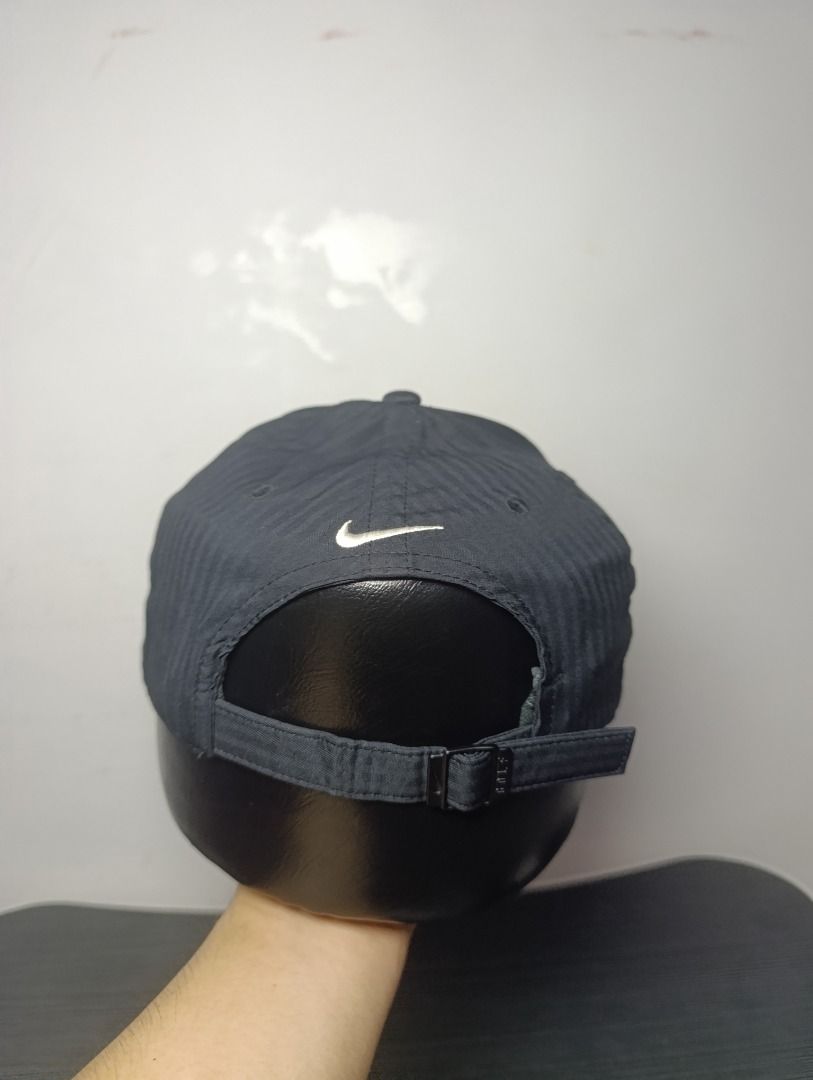 Nike Legacy91 Dri-FIT Black Golf450 Cap (Category: Caps & Hats) located in Pasig City. Submitted by firstpick_thrift (Listing ID 1466772997, Image 3). Description: - Color: Classic Black - Material: Nike Dri-FIT (keeps you cool and dry) - Design: Structured panels with subtle vertical striped texture - Branding: Embroidered white Swoosh on front and back - Closure: Adjustable strap with metal buckle for a custom fit - Condition: Excellent, clean 