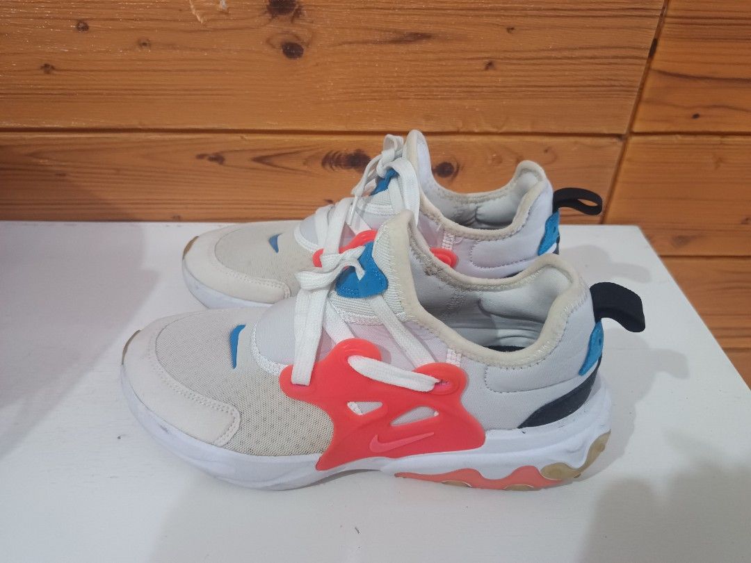 Nike React Presto Kids Shoes Size US 4Y (Category: Babies & Kids Fashion) located in Rizal. Submitted by ethelfranc54595 (Listing ID 1466591310, Image 2). Description: - Brand: Nike React Presto - Colorway: White with bright orange and blue accents - Size: US 4Y / UK 3.5 / EUR 36 - Features: Comfortable foam soles with rubber pods and convenient heel pull tabs - Condition: Normal signs of wear on uppers and soles; laces are clean - Perfect for da