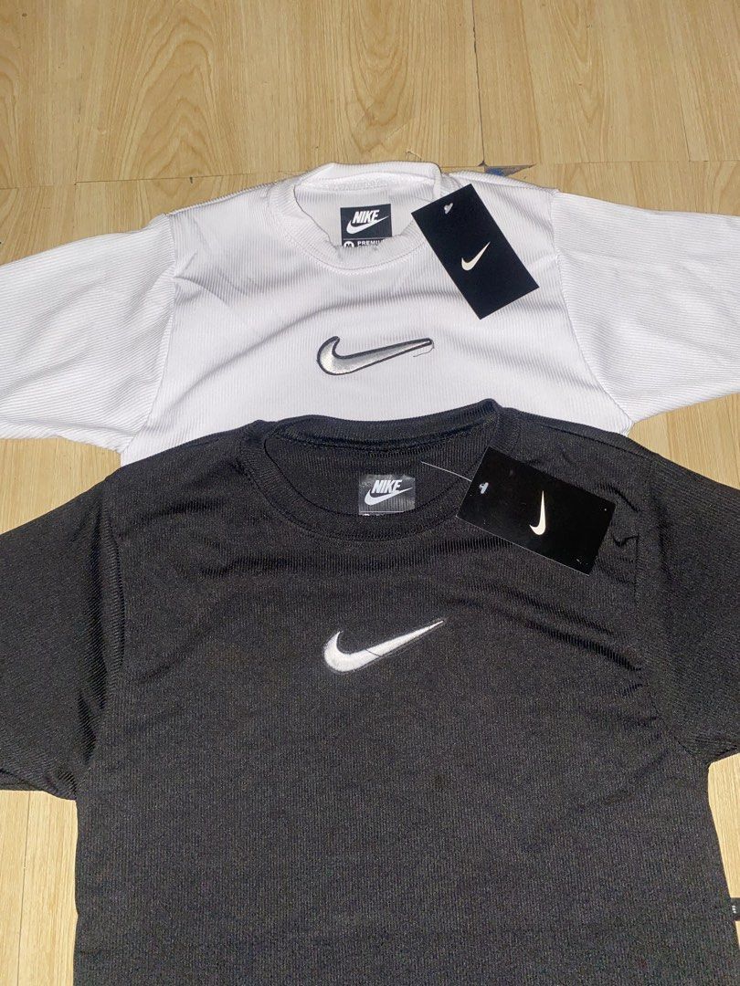 Nike Ribbed T-Shirts Bundle White and Black (Category: Shirts) located in Manila. Submitted by hrg-thrifted (Listing ID 1466722798, Image 2). Description: - Brand: Nike - Item: Ribbed t-shirts (Bundle of 2: White and Black) - Size: Medium (Brand new with original store tags attached) - Design: Classic crew neck, short sleeves - Details: Centered metallic silver swoosh logo embroidery - Material: Soft and stretchy fabric texture.