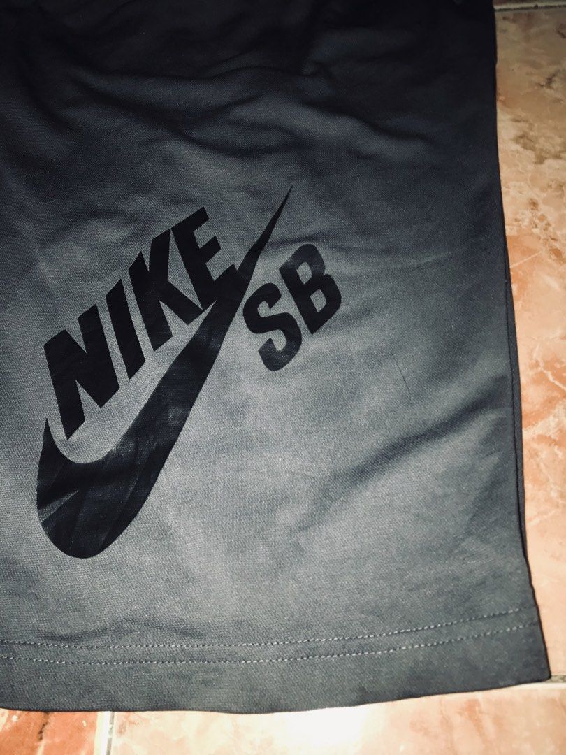 Nike SB Black Athletic Shorts (Category: Shorts) located in Tayabas. Submitted by mf.archives (Listing ID 1466648475, Image 3). Description: Nike SB dark grey athletic shorts with elastic waistband and drawstring. Big black Nike SB logo graphic printed down the front left leg. Small pocket on the back right side featuring a Nike SB woven tag. Breathable athletic fabric, great for skating or everyday casual wear. Standard fit. Nike sb Dri-fit W 25
