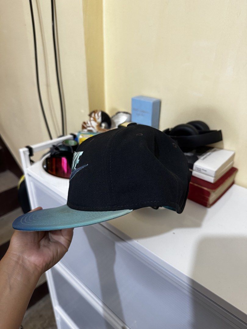 Nike True Snapback Cap Black Teal Gradient (Category: Caps & Hats) located in Baler. Submitted by sidequester (Listing ID 1466569945, Image 2). Description: - Brand: Nike True - Style: Snapback cap - Color: Black with teal gradient brim - Logo: Embroidered teal and silver iridescent Nike logo on front - Closure: Adjustable strap with metal clasp - MOP: Any online bank or e-wallets - MOD: Can do meet up and ship nationwide - Can offer discount or 