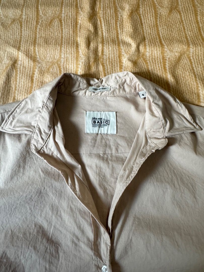 Niko and... Basic Button-Down Shirt Size 4 Nude Beige (Category: Shirts) located in Calasiao. Submitted by clothesbykim (Listing ID 1466744690, Image 2). Description: - Brand: Niko and... - Style: Basic button-down shirt - Color: Nude beige - Size: 4 - Details: Long sleeves, classic collar, curved hemline, front button closure - Fabric: Smooth and lightweight - Condition: Great pre-loved condition - Perfect for: Office attire, daily wear, or casu