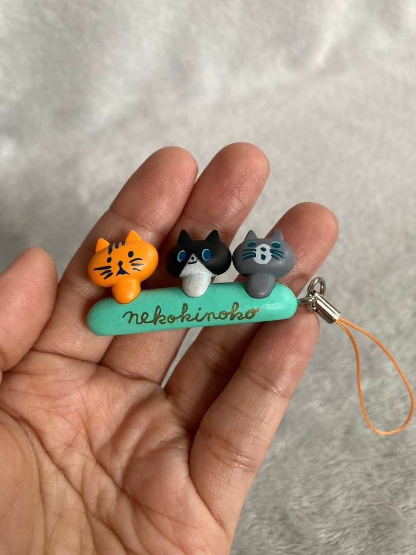 Noraneko Nekokinoko Cat Charm (Category: Character Goods) located in Rizal. Submitted by sheeraay (Listing ID 1466652086, Image 1). Description: - Authentic Nekokinoko phone strap - Features 3 colorful cat figures: orange, black & white, and grey - Mint green bar accented with stylish gold lettering - Includes an orange loop strap for easy attachment - Official copyright stamp located on the bottom - Perfect accessory for cat lovers and phone cus
