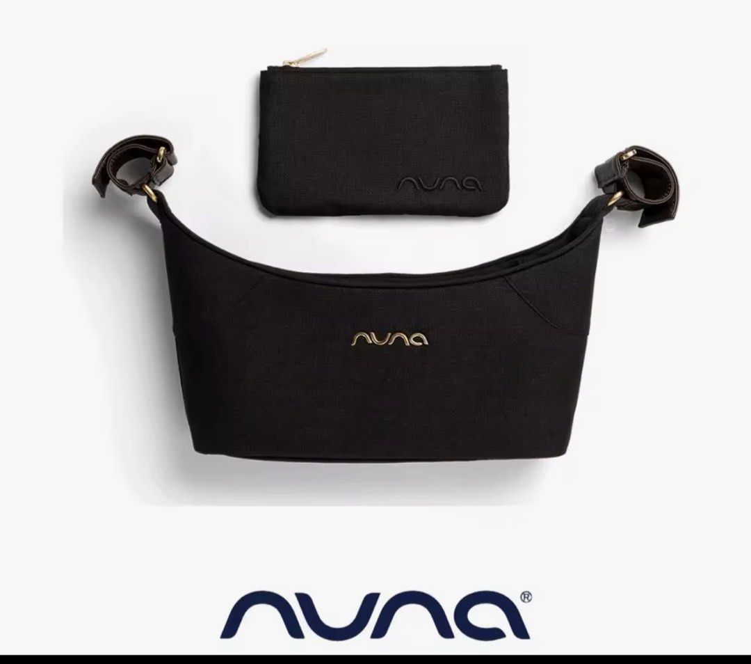 Nuna Black Stroller Caddy Bag with Pouch (Category: Strollers) located in Manila. Submitted by ririkah (Listing ID 1466746313, Image 1). Description: - Authentic Nuna black stroller caddy bag - Features elegant gold lettering logo on the front - Includes a matching zippered pouch with embroidered branding - Equipped with sturdy stroller handlebar attachments and gold hardware - Must-have, stylish accessory for parents on the go.