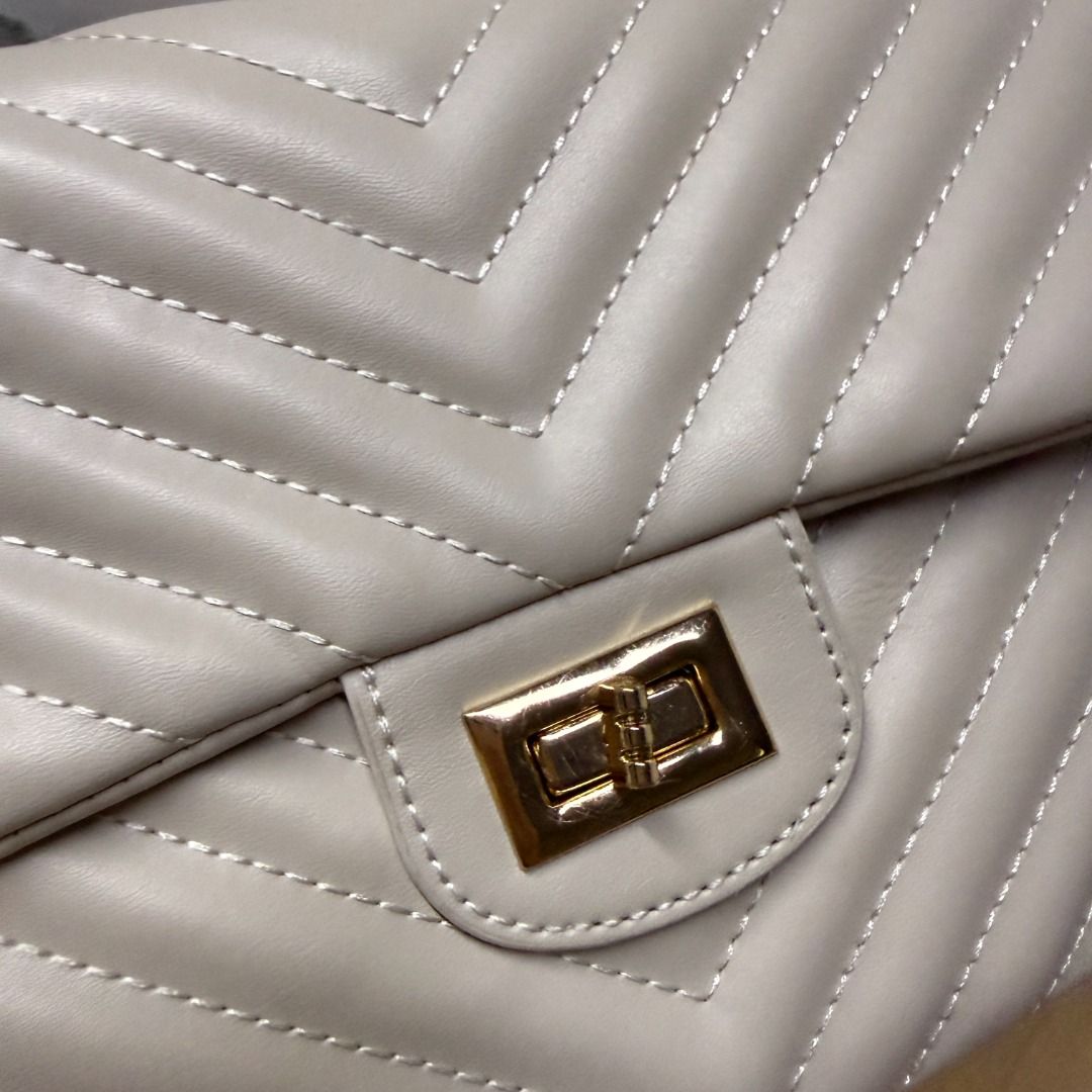 Off-white Chevron Quilted Shoulder Bag with Gold Chain (Category: Luxury Bags & Wallets) located in Mandaluyong City. Submitted by jldlnd (Listing ID 1466677731, Image 3). Description: - Used once only for a wedding - Color: Off-white / Cream - Material: Faux leather with all-over chevron quilting - Hardware: Gold-tone box chain strap and twist-lock clasp - Design: Structured rectangular shape with gusseted sides - Condition: Clean interior and f