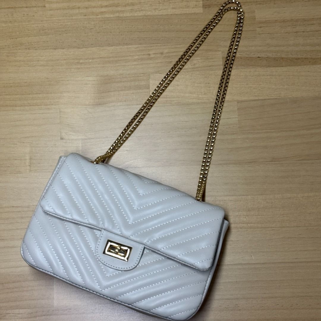 Off-white Chevron Quilted Shoulder Bag with Gold Chain (Category: Luxury Bags & Wallets) located in Mandaluyong City. Submitted by jldlnd (Listing ID 1466677731, Image 1). Description: - Used once only for a wedding - Color: Off-white / Cream - Material: Faux leather with all-over chevron quilting - Hardware: Gold-tone box chain strap and twist-lock clasp - Design: Structured rectangular shape with gusseted sides - Condition: Clean interior and f