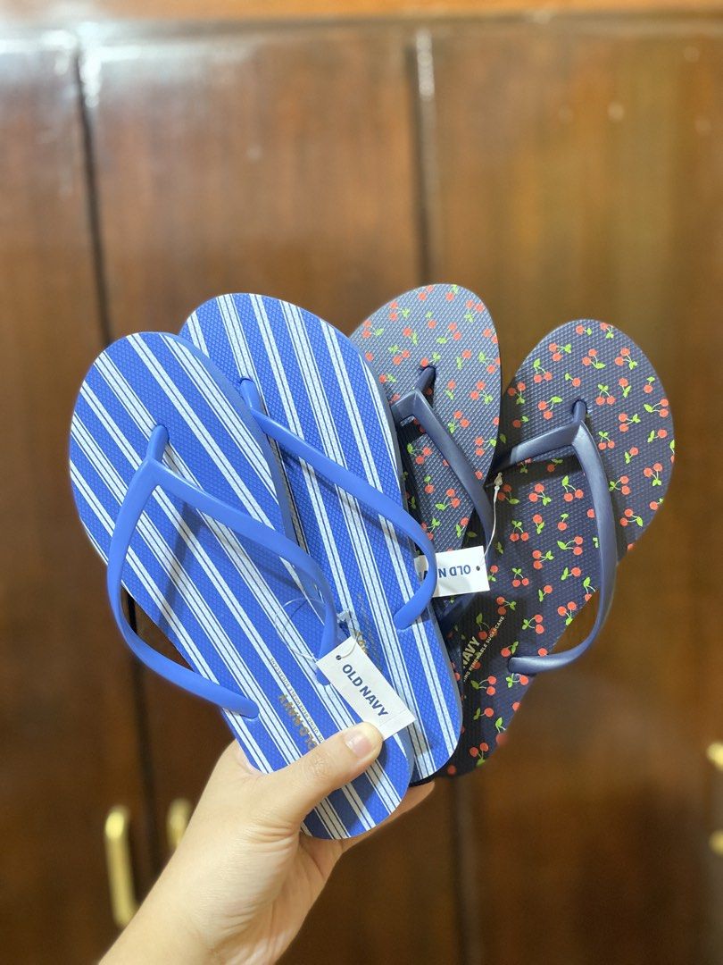 Old Navy Flip Flops Cherry and Stripe Pairs US6 (Category: Slippers and slides) located in Batangas. Submitted by lux_kimmy (Listing ID 1466674580, Image 2). Description: - Brand: Old Navy - Quantity: 2 pairs - Condition: Brand new with tags attached (Never worn) - Pair 1: Navy blue base with red cherry all-over print - Pair 2: Blue and white vertical stripes - Ideal for: Beach trips, vacations, and casual warm-weather wear US 6 (Both) ₱250 each 
