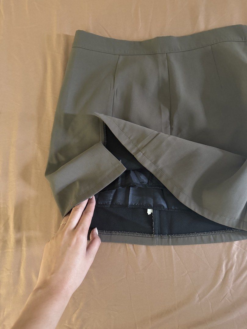 Olive Green/Brownish Skort (Category: Skirts) located in Pasay City. Submitted by cheyennesayson (Listing ID 1466572855, Image 2). Description: - Size: Medium (M) - waist 26-27 - Material & Design: Structured fabric with front seam details and a subtle side slit - Comfort & Coverage: Built-in black lining underneath for extra confidence - Closure: Convenient side zipper - Versatility: Clean cut, perfect for casual outings or paired with blouses f