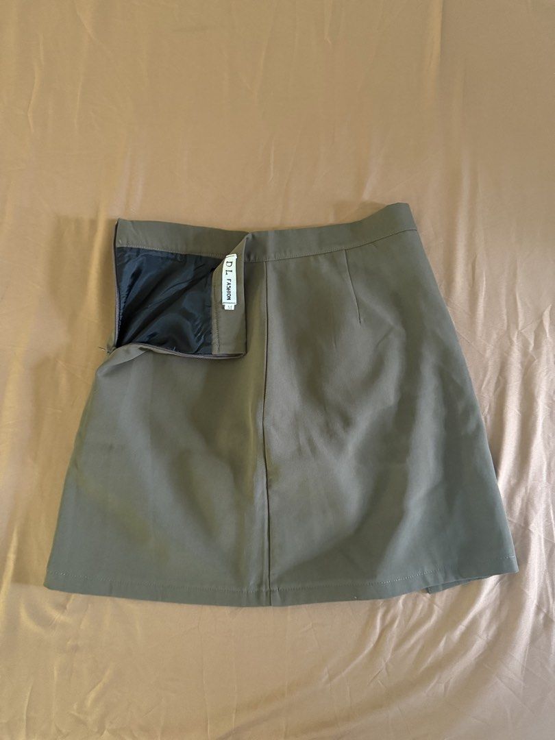 Olive Green/Brownish Skort (Category: Skirts) located in Pasay City. Submitted by cheyennesayson (Listing ID 1466572855, Image 3). Description: - Size: Medium (M) - waist 26-27 - Material & Design: Structured fabric with front seam details and a subtle side slit - Comfort & Coverage: Built-in black lining underneath for extra confidence - Closure: Convenient side zipper - Versatility: Clean cut, perfect for casual outings or paired with blouses f