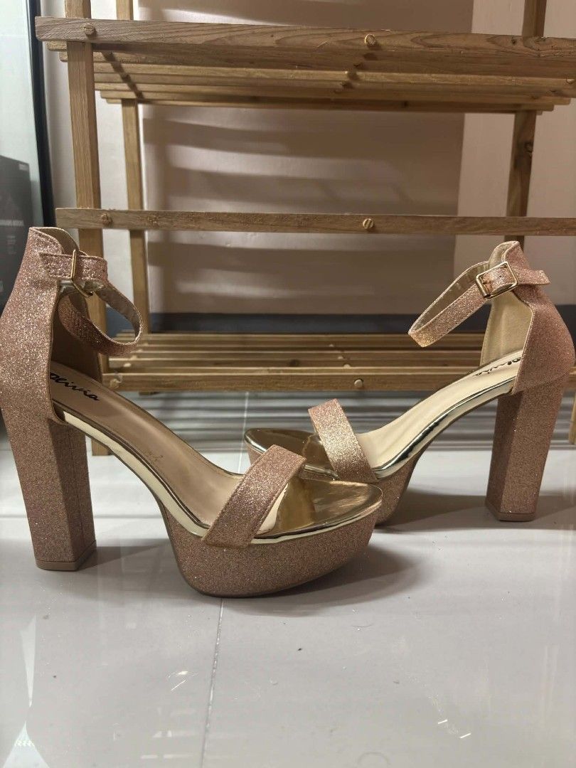 Olivia Rose Gold Glitter Platform Heels Ankle Strap (Category: Heels) located in Mandaluyong City. Submitted by zedchu (Listing ID 1466681307, Image 2). Description: - Brand/Style: Olivia rose gold glitter platform heels - Heel & Sole: Chunky block heel with a thick platform for extra comfort - Details: Adjustable ankle strap with buckle closure and chic metallic gold inner lining - Condition: Worn only a few times with minimal wear on the soles 
