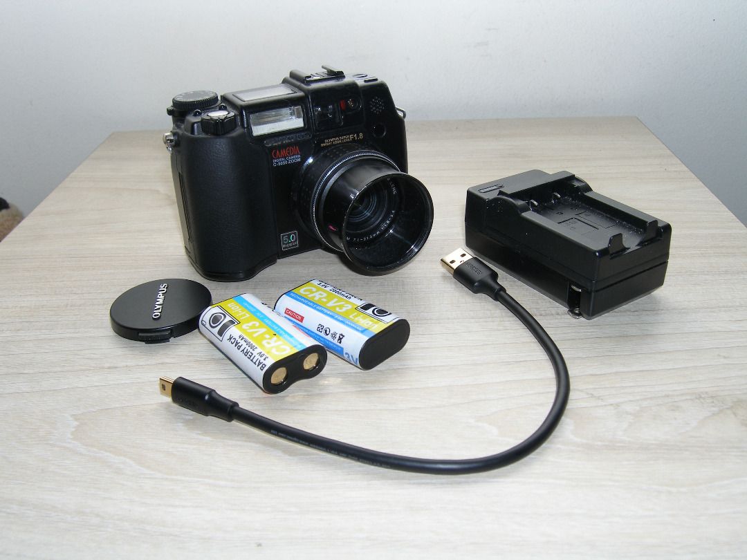 Olympus Camedia C-5050 Zoom Digicam (Category: Cameras) located in Quezon City. Submitted by melomonserrat (Listing ID 1466476157, Image 3). Description: - 5 Megapixel CCD Sensor - 35-105mm (full frame equivalent), f1.8 - f2.6 lens - Magnesium alloy body - tiltable screen - can use CF Cards, SmartMedia cards, and XD cards all at the same time - 800+ photos on HQ image setting, 270+ on SHQ (130+ on RAW) with a 1GB CF Card - built-in flash works, h