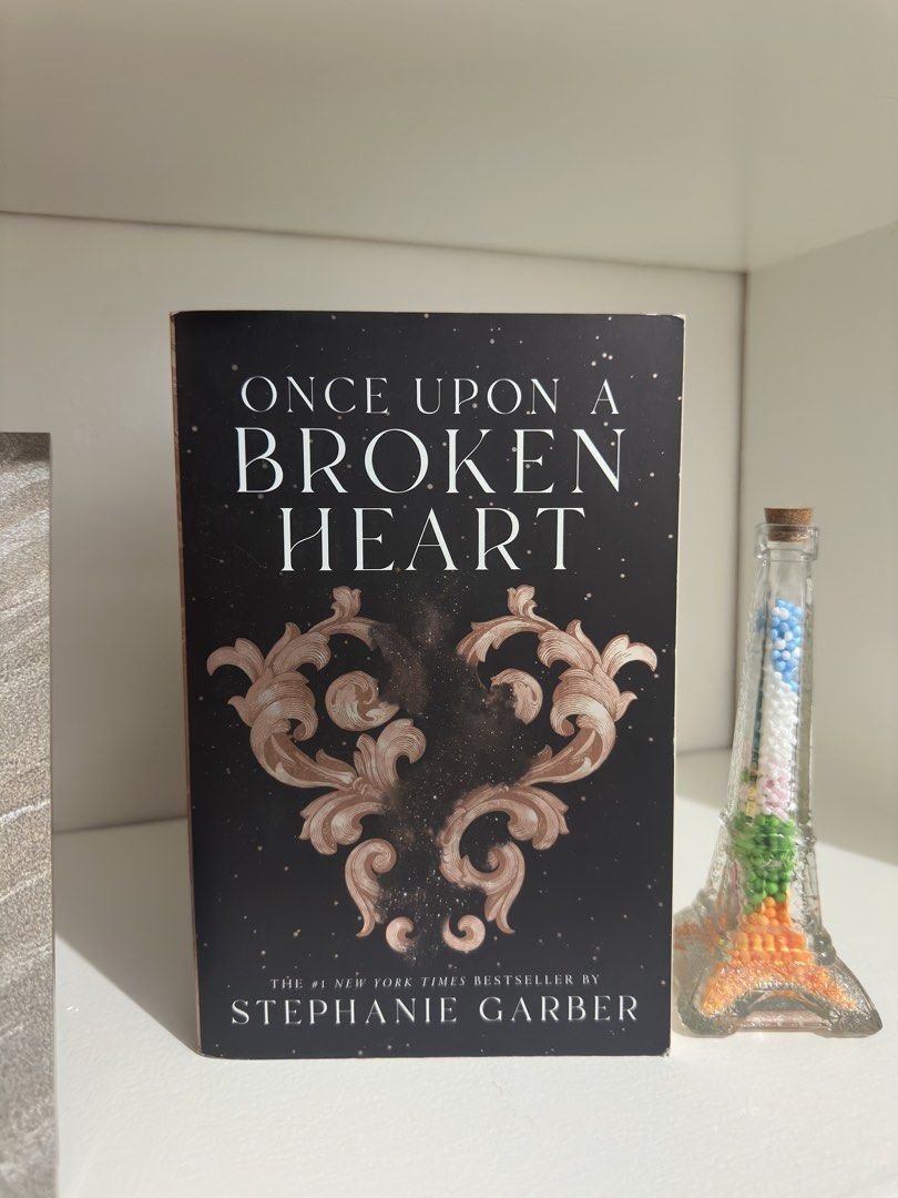 Once Upon A Broken Heart by Stephanie Garber (Category: Storybooks) located in Manila. Submitted by atlantis386 (Listing ID 1466719926, Image 1). Description: - Title & Author: Once Upon A Broken Heart by Stephanie Garber - Status: New York Times Bestseller - Condition: excellent spine, no folded pages or internal marks - Appearance: Stunning black cover with ornate scroll design and starry background - Genre: Perfect fantasy romance read.