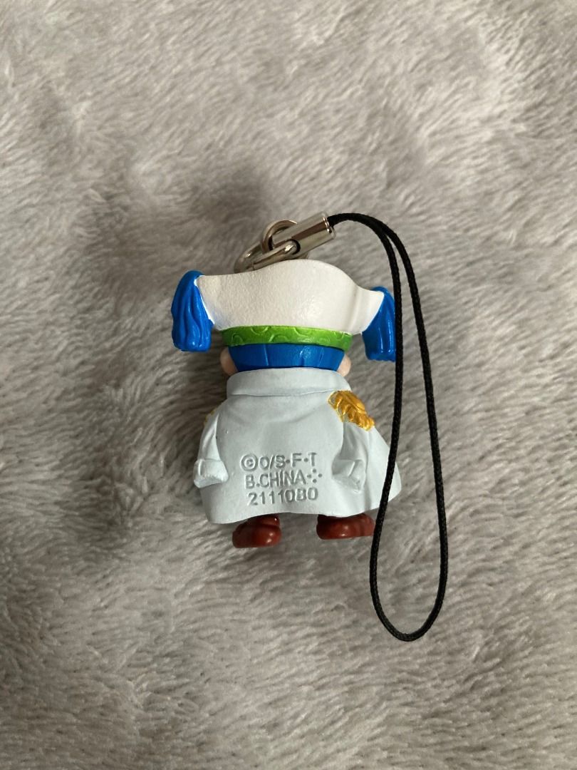 One Piece Buggy the Clown Figure Strap Keychain (Category: Character Goods) located in Rizal. Submitted by sheeraay (Listing ID 1466653620, Image 3). Description: - Character: Buggy the Clown from One Piece - Design: Marine captain outfit with white coat - Features: Includes black strap attachment and official copyright stamp on the back - Condition: Clean paint work and great overall condition - Type: Mini figure keychain.