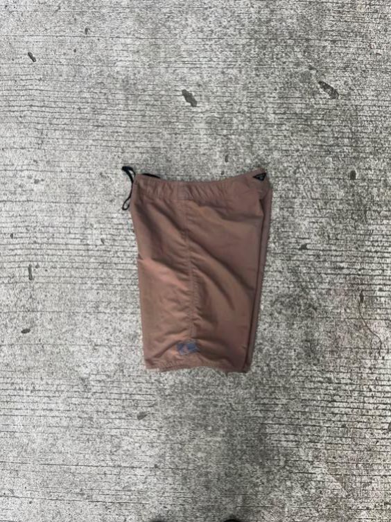O'Neill Brown Board Shorts (Category: Swim Trunks & Board Shorts) located in Sipalay. Submitted by yon.thrifter (Listing ID 1466773437, Image 2). Description: - Brand: O'Neill - Color: Solid brown with white inner waistband and black drawstring - Material: Quick-drying fabric for all-day comfort - Pockets: Small side cargo pocket with button closure and logo tag, plus a back pocket with matching button - Fit: Standard fit - Ideal for: Beach trips