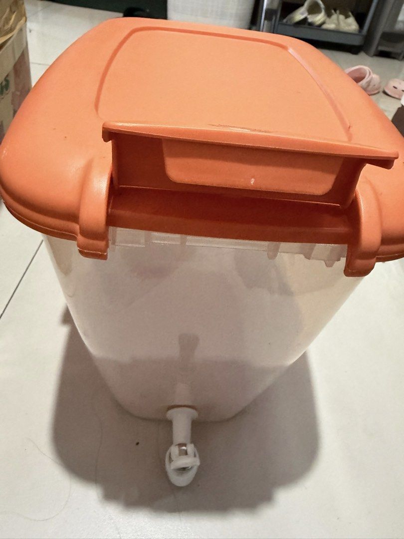 Orange Lid Storage Container with Dispenser Spout (Category: Food Organization & Storage) located in Quezon City. Submitted by bubspreloved (Listing ID 1466724344, Image 2). Description: - Clear body with bright orange lid and built-in handle - Equipped with a convenient white dispensing tap at the front - Secure latches keep the lid tightly shut to prevent leaks - Clean interior and 100% ready for use - Perfect for parties, camping, or everyday 