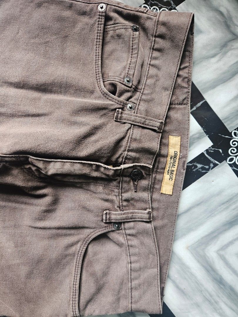 Original Basic Brown Slim Fit Straight Pants (Category: Trousers) located in Manila. Submitted by shanshan.river (Listing ID 1466593317, Image 3). Description: - Color: Versatile basic brown - Fit: Slim fit straight style - Design: Classic five-pocket, button fly, and belt loops - Condition: Excellent, no damage spotted - Fabric: Clean stitching and structured material.