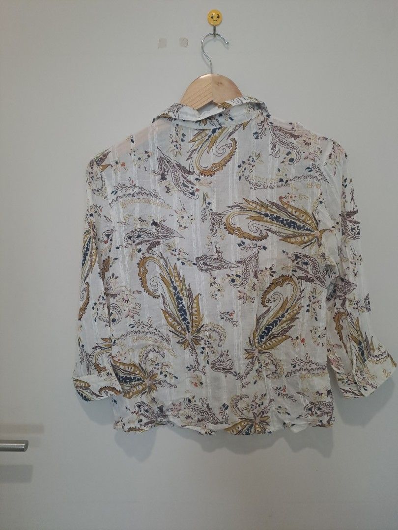 Paisley longsleve (Category: Longsleeves) located in Manila. Submitted by joanbalde39643 (Listing ID 1466666745, Image 2). Description: The image shows a white button-up shirt featuring a multicolor paisley print, a classic collar, a chest pocket, and three-quarter sleeves..