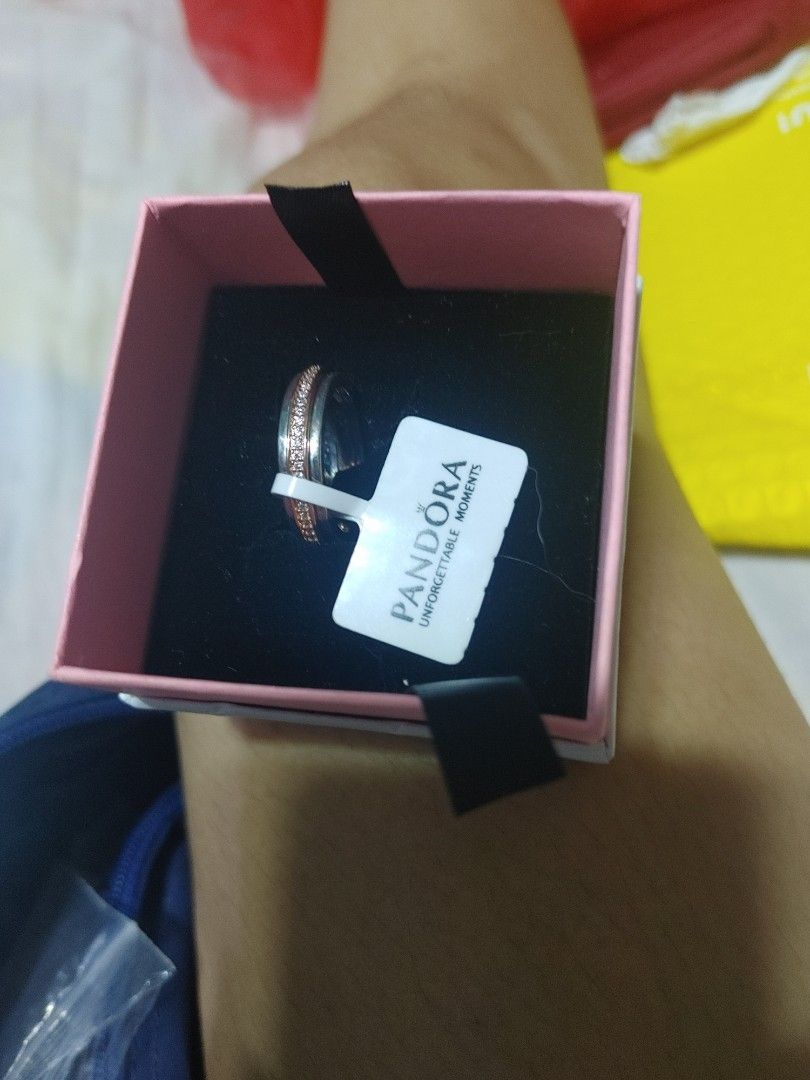 Pandora Two-Tone Pave Ring with Box (Category: Rings) located in Pasig City. Submitted by magic5 (Listing ID 1466686204, Image 2). Description: - Authentic Pandora two-tone ring with sparkling pave crystals - Features engraved brand name along the outer edge - Brand new, never worn, with original tag attached - Comes with a lovely pink Pandora gift box - Ideal for gifts or personal collection - PM for inquiries or fast shipping!.