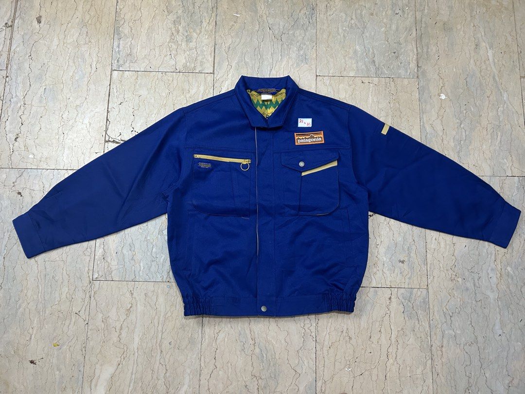 Patagonia Blue Work Jacket With Patch (Category: Coats, Jackets and Outerwear) located in Mandaluyong City. Submitted by 0lg2026 (Listing ID 1466750480, Image 1). Description: - Brand: Patagonia - Color: Deep blue - Style: Work jacket with classic collar and banded hem - Features: Front pockets, button closure, and sturdy daily-wear construction - Fit/Details: Tag includes exact sizing measurements - Ideal for: Layering and casual streetwear.