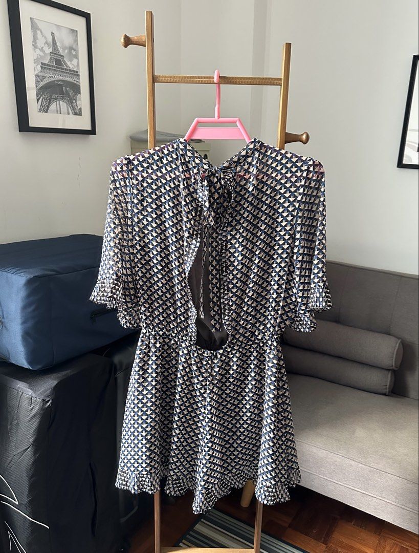 Patterned romper (Category: Rompers) located in Singapore. Submitted by jchmsell (Listing ID 1466728231, Image 2). Description: - Cute romper - Geometric and floral print - Short flutter sleeves - Ruffled hem - Open back with tie detail - Elasticated waist - Perfect for casual outings or nights out Ptp- 42cm Length- 77cm Condition: like new .